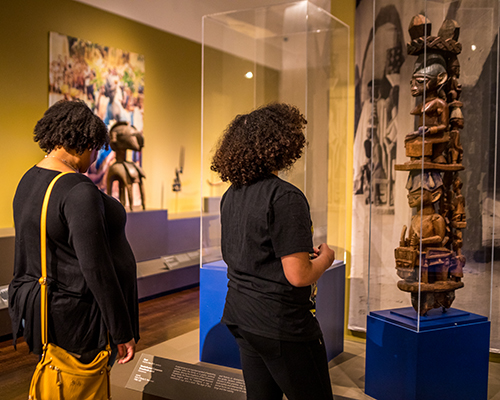 A guest and their parent explore the galleries