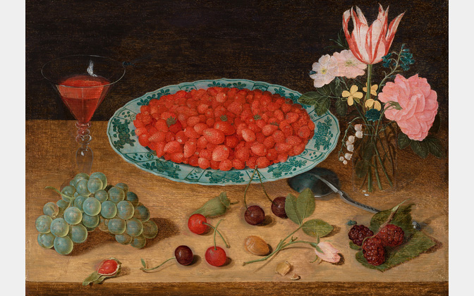 Tabletop with glass of wine, bunch of grapes, bowl of strawberries, and bouquet of flowers