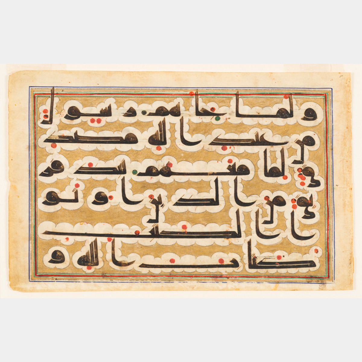 Arabic writing with red accents on a yellowed page
