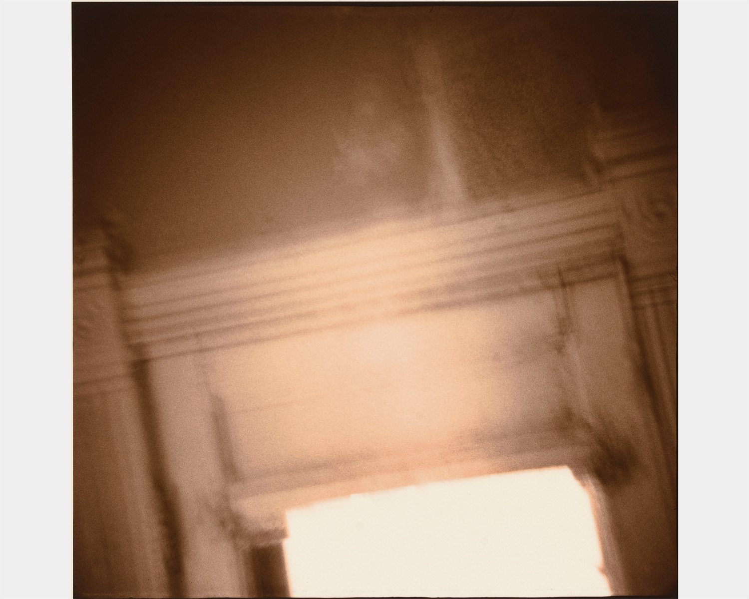 A sepia photo of the top of an open door
