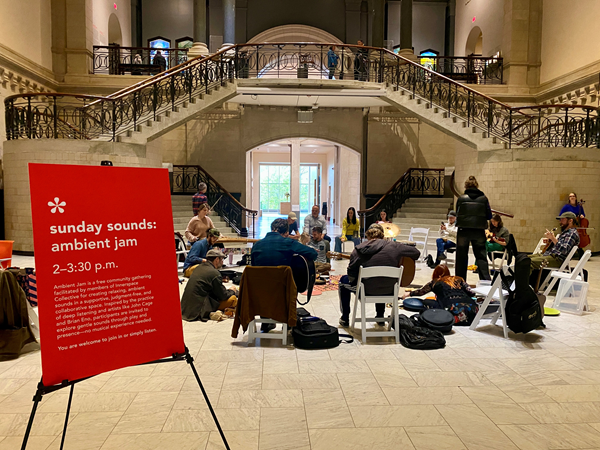 People jam in a circle at the museum