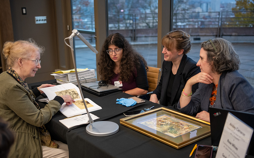 A group of curators talk to a visitor