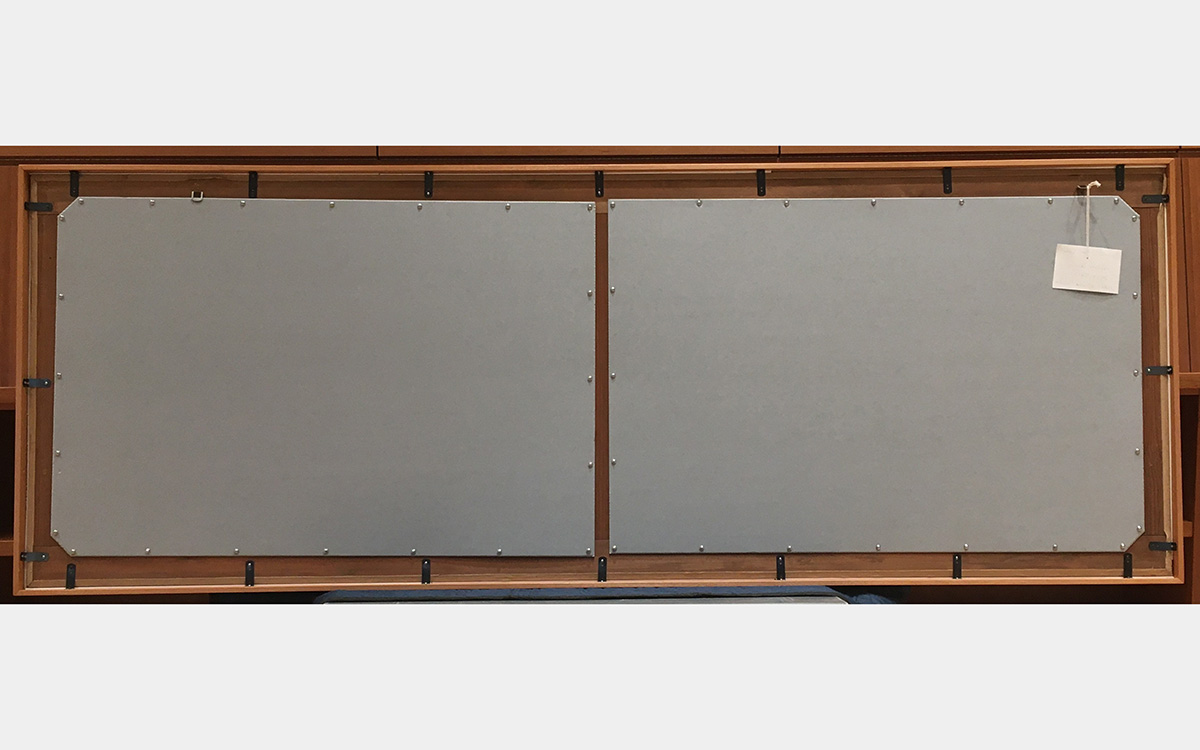 Back of framed painting with gray rectangles attached