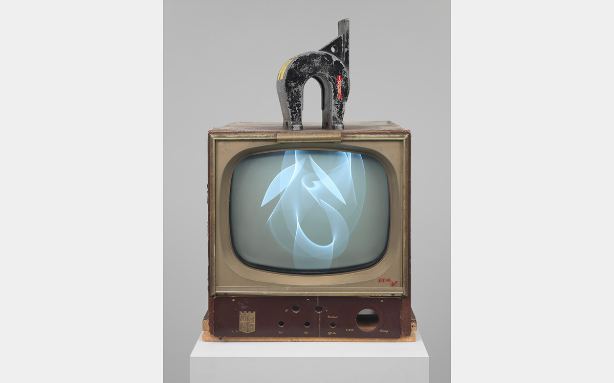 Vintage television with a large magnet on top and scrambled image