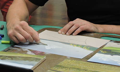 visitor working on a drawing