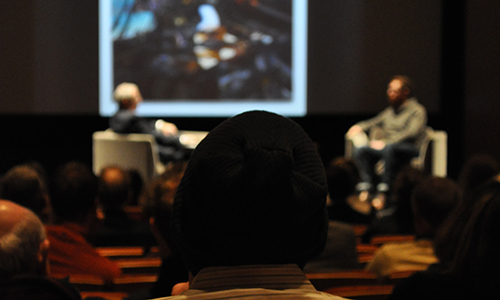 Visitors in the Fath Auditorium receiving a lectture