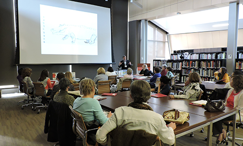 speaker giving a presentation in the Mary R. Schiff library