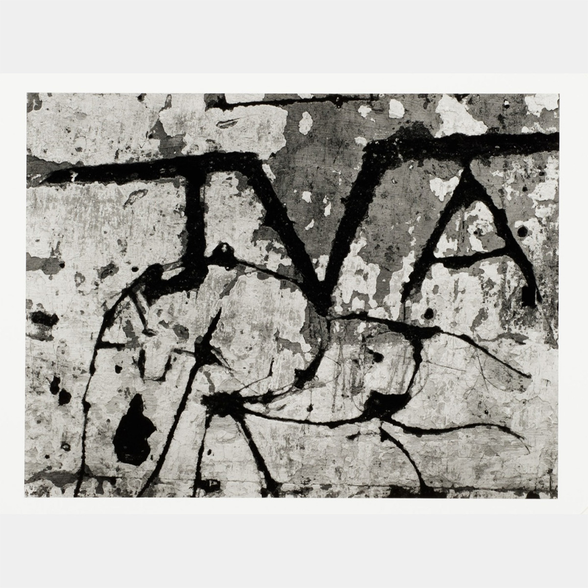 "JVA" written on a cracked concrete wall