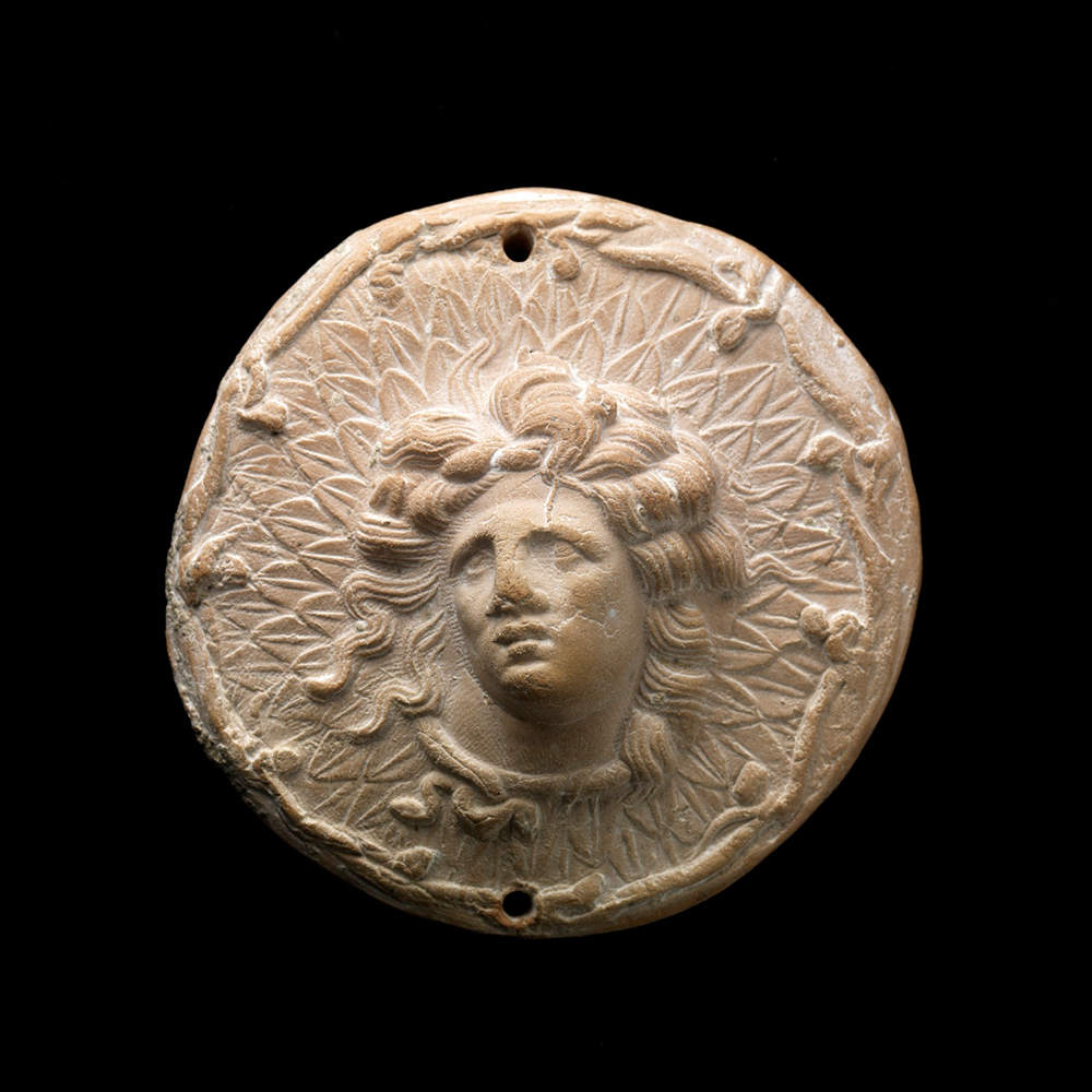 Miniature Votive Shield with Head of Alexander the Great as Gorgoneion, 3rd century BCE, Greece, moldmade terracotta, Cincinnati Art Museum, Museum Purchase: Lawrence Archer Wachs Fund, 2007.66