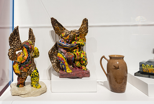 Detail of several painted ceramic cherub figures with gold and yellow coloring