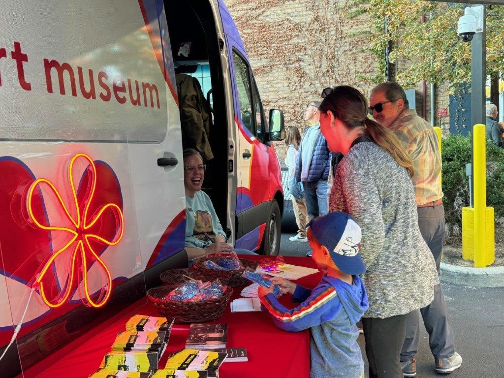 People enjoying art making outside CAM Cruiser