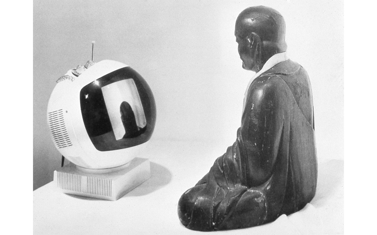 Buddha stature looks at itself in a round TV