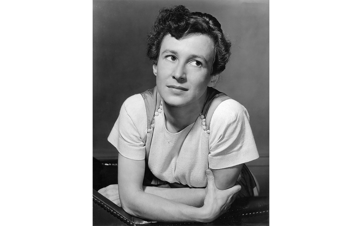 Black and white portrait of woman in a white shirt.
