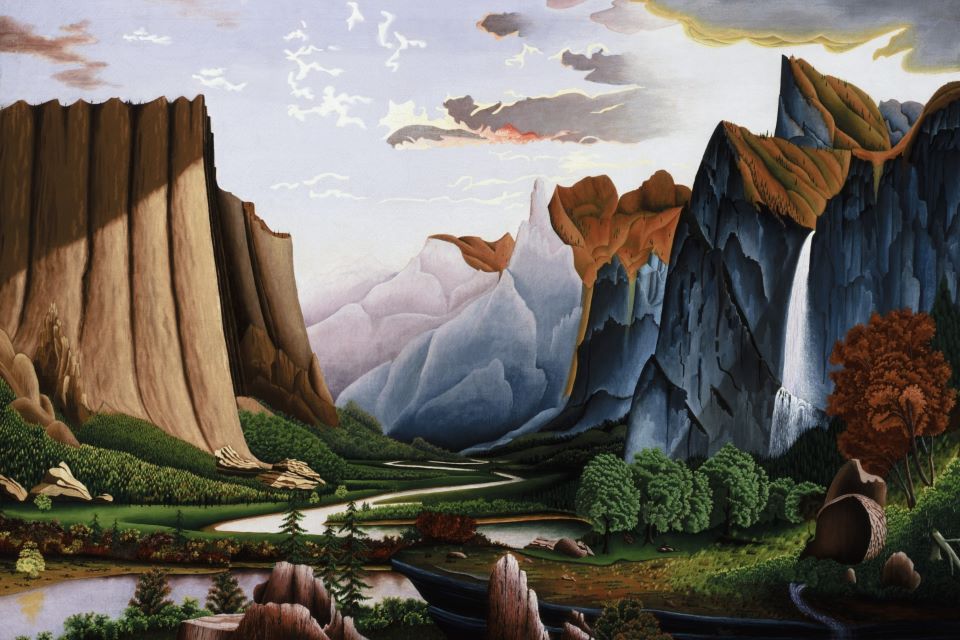 Mountains and cliffs frame a green valley with a winding river below a dramatic sky.