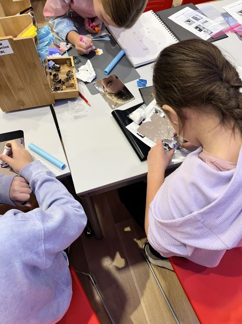 Above view of kids making art at a table