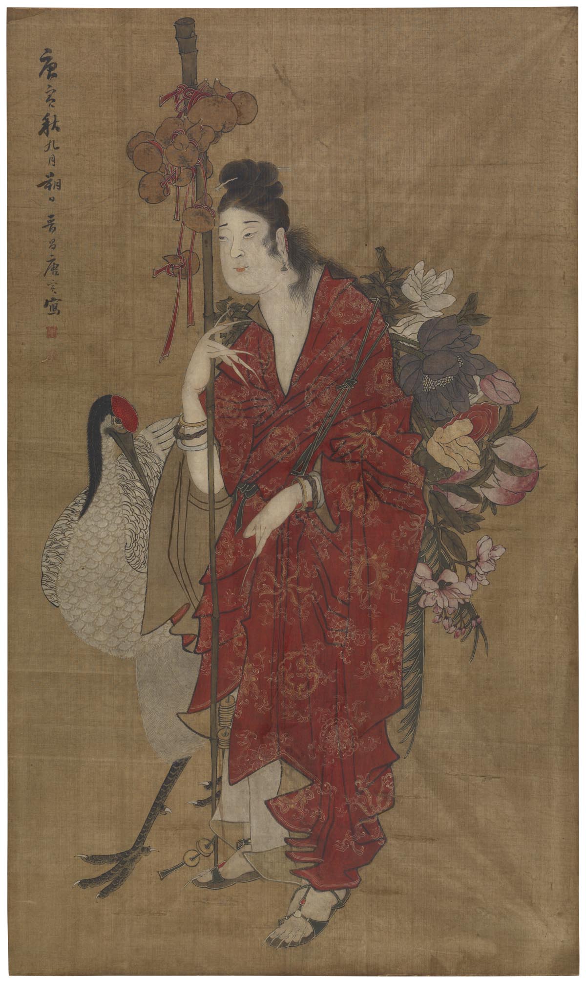 A crane stands beside a woman in a red robe.