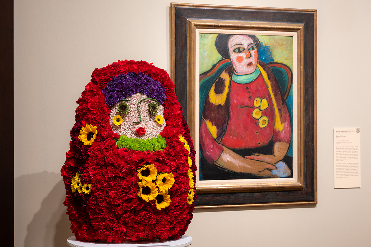 A large red floral arrangement with a face