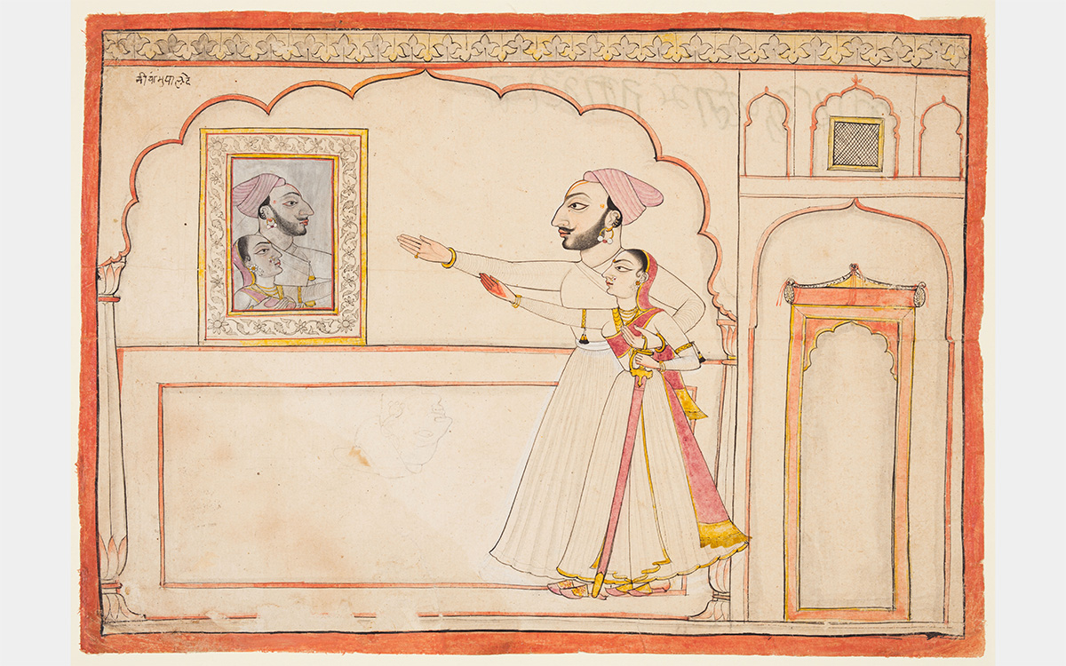 A couple look at their reflection in a mirror