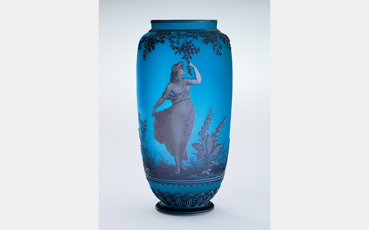 Blue vase with image of women walking through a field (?) and holding onto a hanging branch.