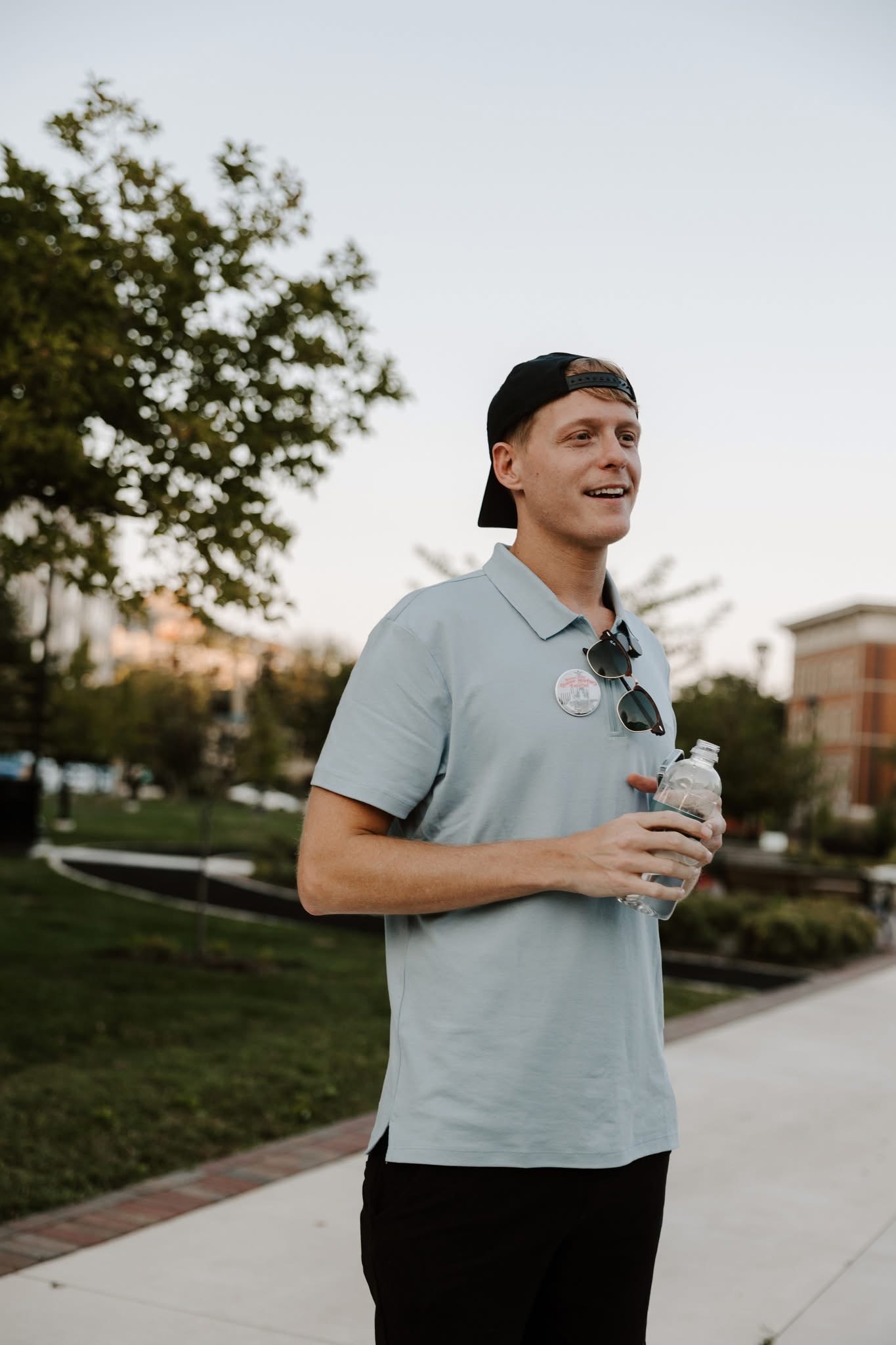 A white person in a polo and hat