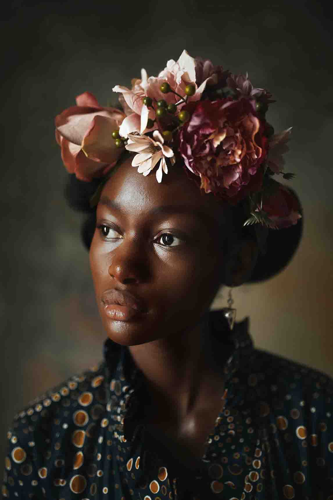A Black woman with a pink flower crown
