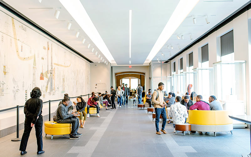 Visitors converse and lounge at a seating area at CAM