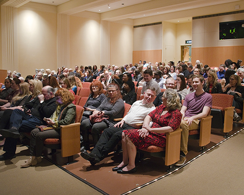 An auditorium full of people sitting
