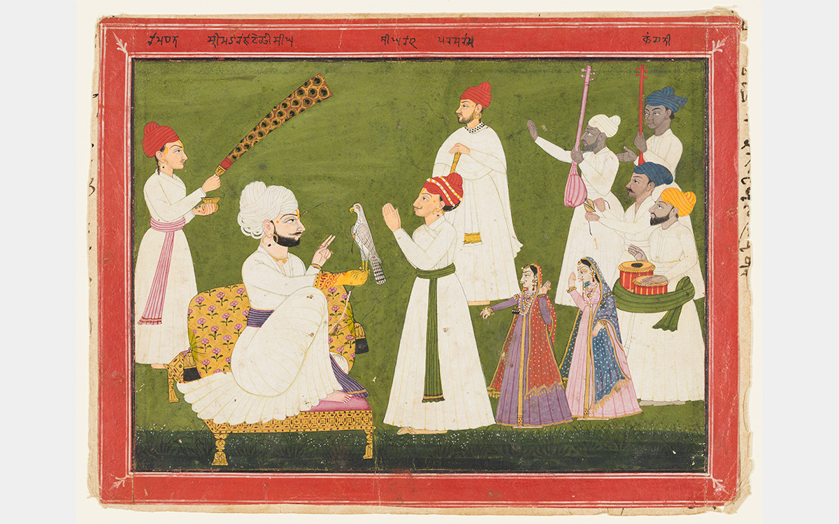 A group gathers before a man holding a bird