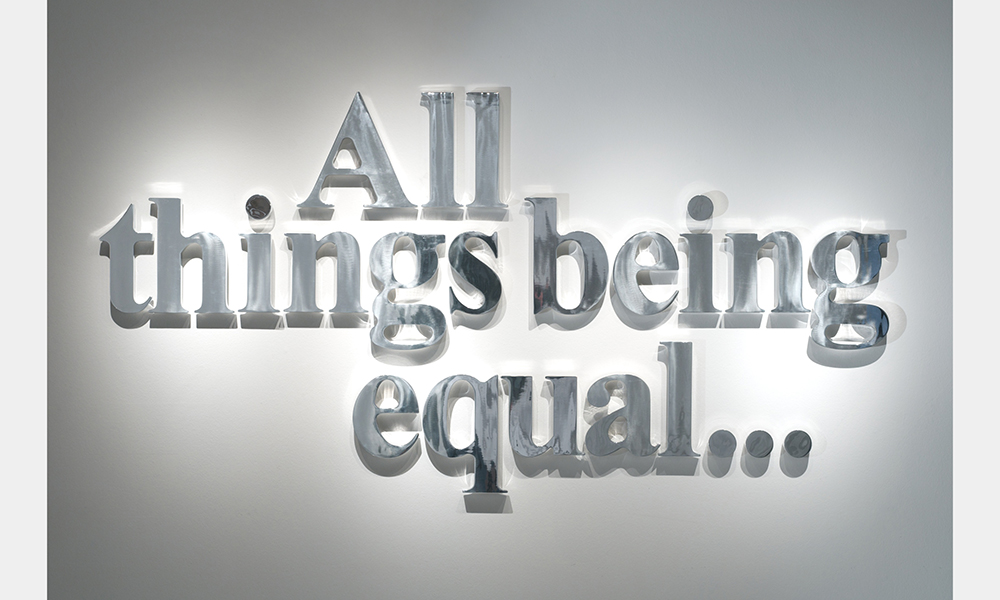 Hank Willis Thomas' All Things Being Equal..., stainless steel letters hung on the wall that read the title of the piece