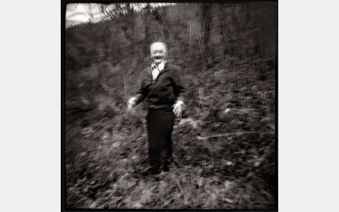 Nancy Rexroth's Emmet Dances the Jig, blurry black and white photograph of an old man dancing in a wooded area