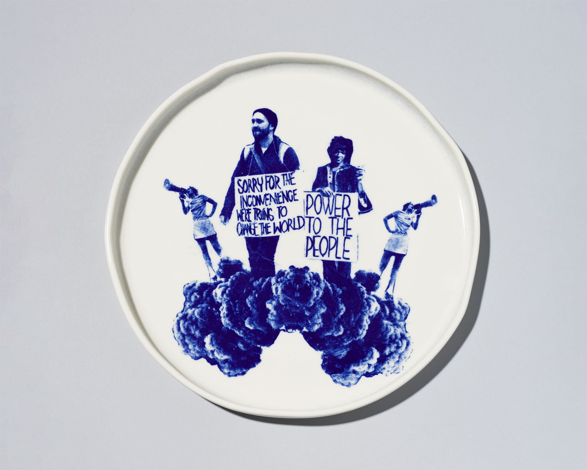 A white plate with blue image of people protesting