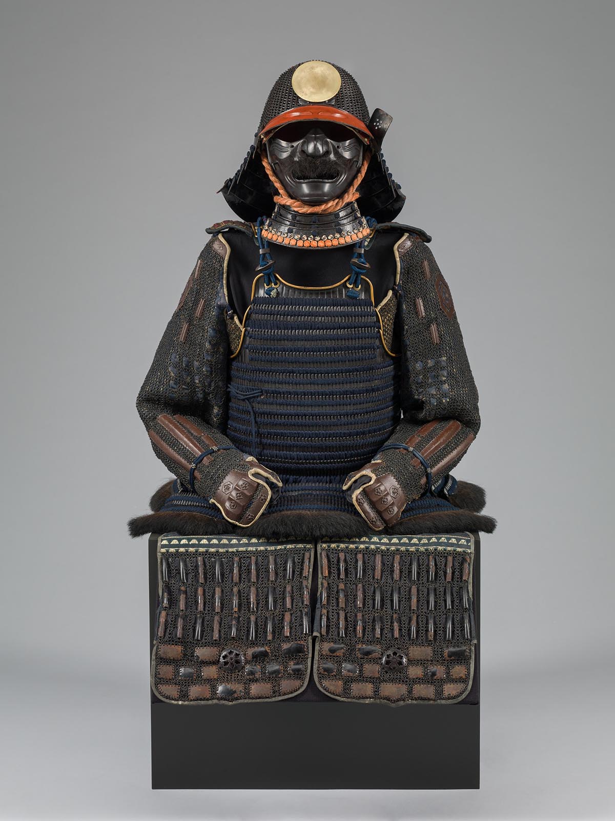 A dark set of armor including a black face mask.