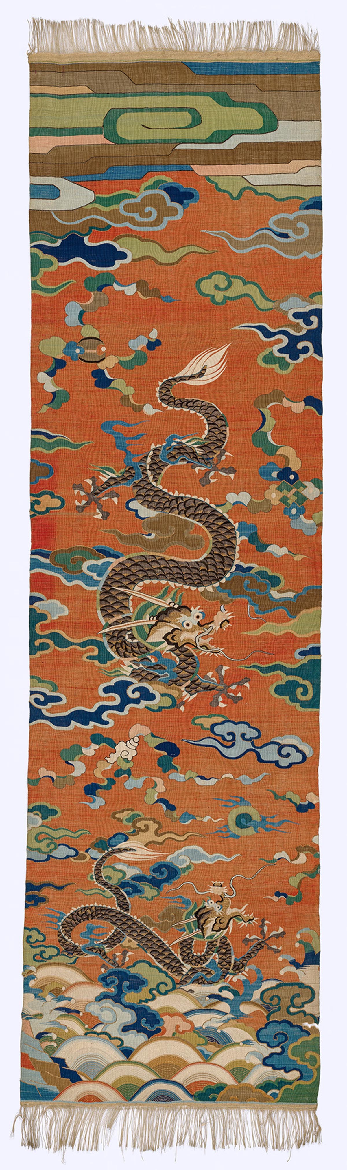 A tapestry depicting two dragons soaring through the air.