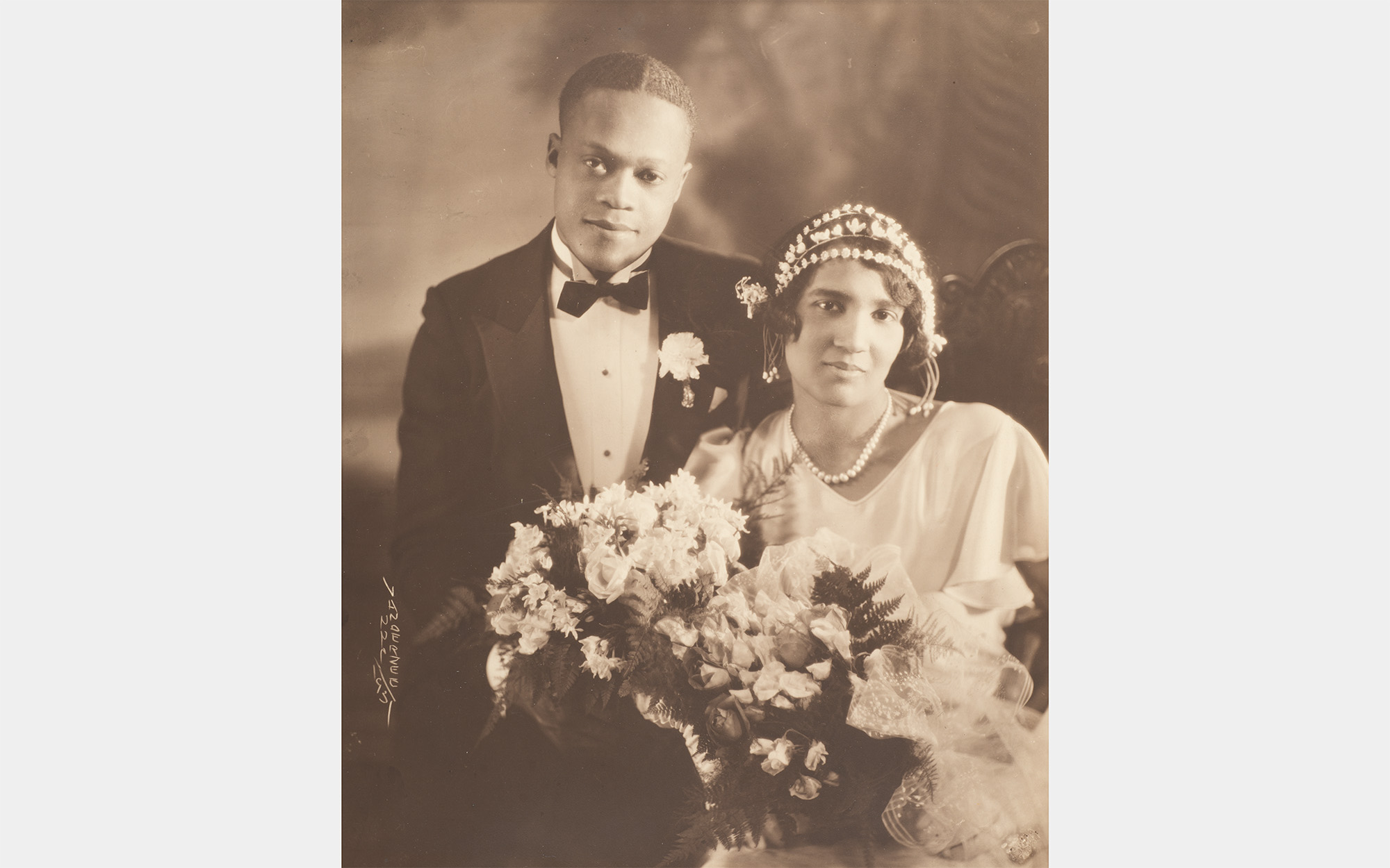 A black and white portrait of a Black couple in formal wear