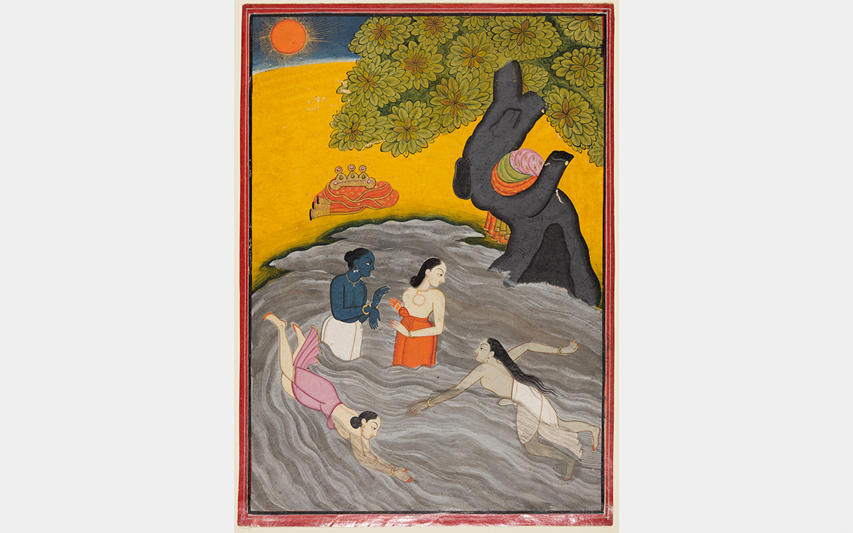 Women swim in a pond under a tree