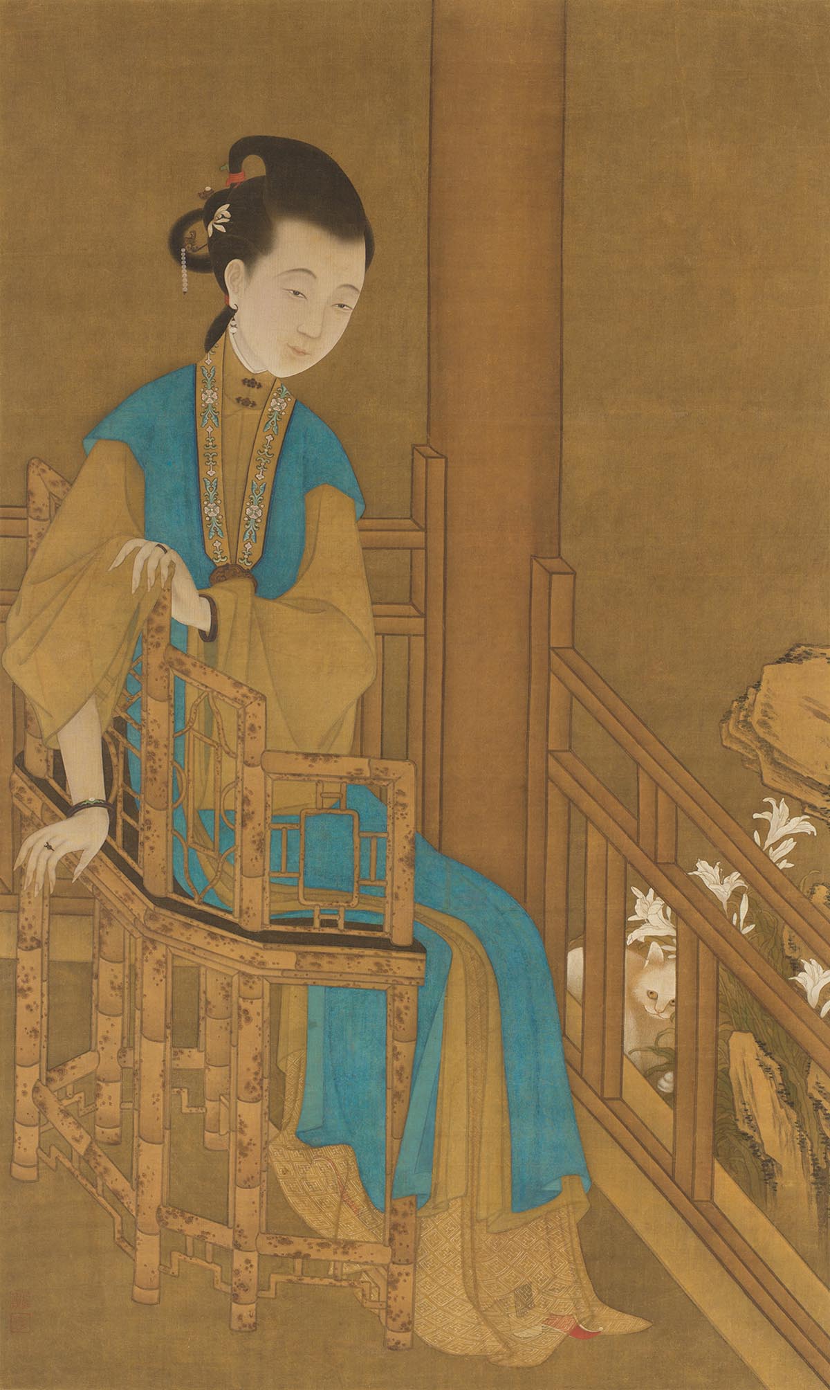 A woman with vibrant teal and gold robes sits on a chair.