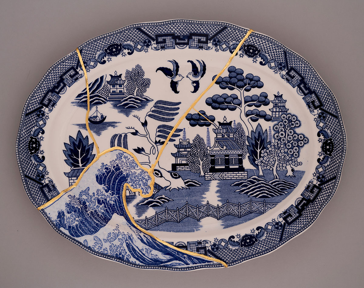 A broken plate with a design on it.