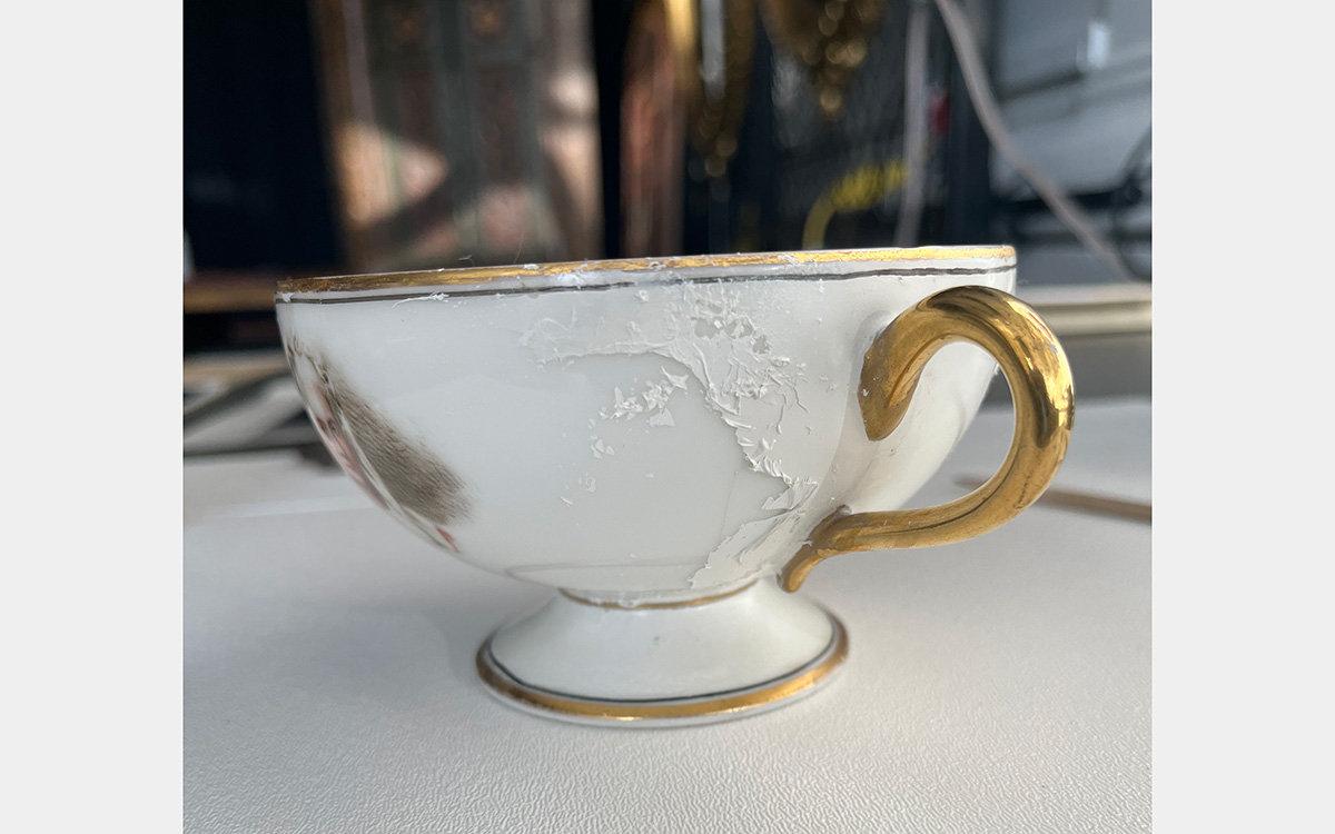 White teacup with gold highlights