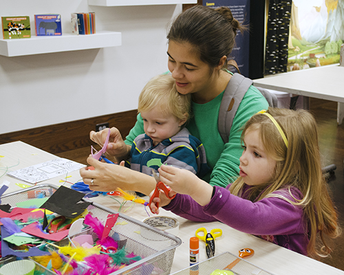 A mother makes art with her two kids