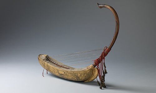 A musical instrument that looks like a boat with a long, curving wooden section on the front.