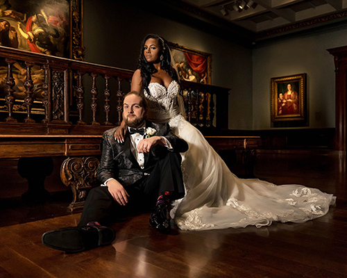 A bride and groom pose in the galleries