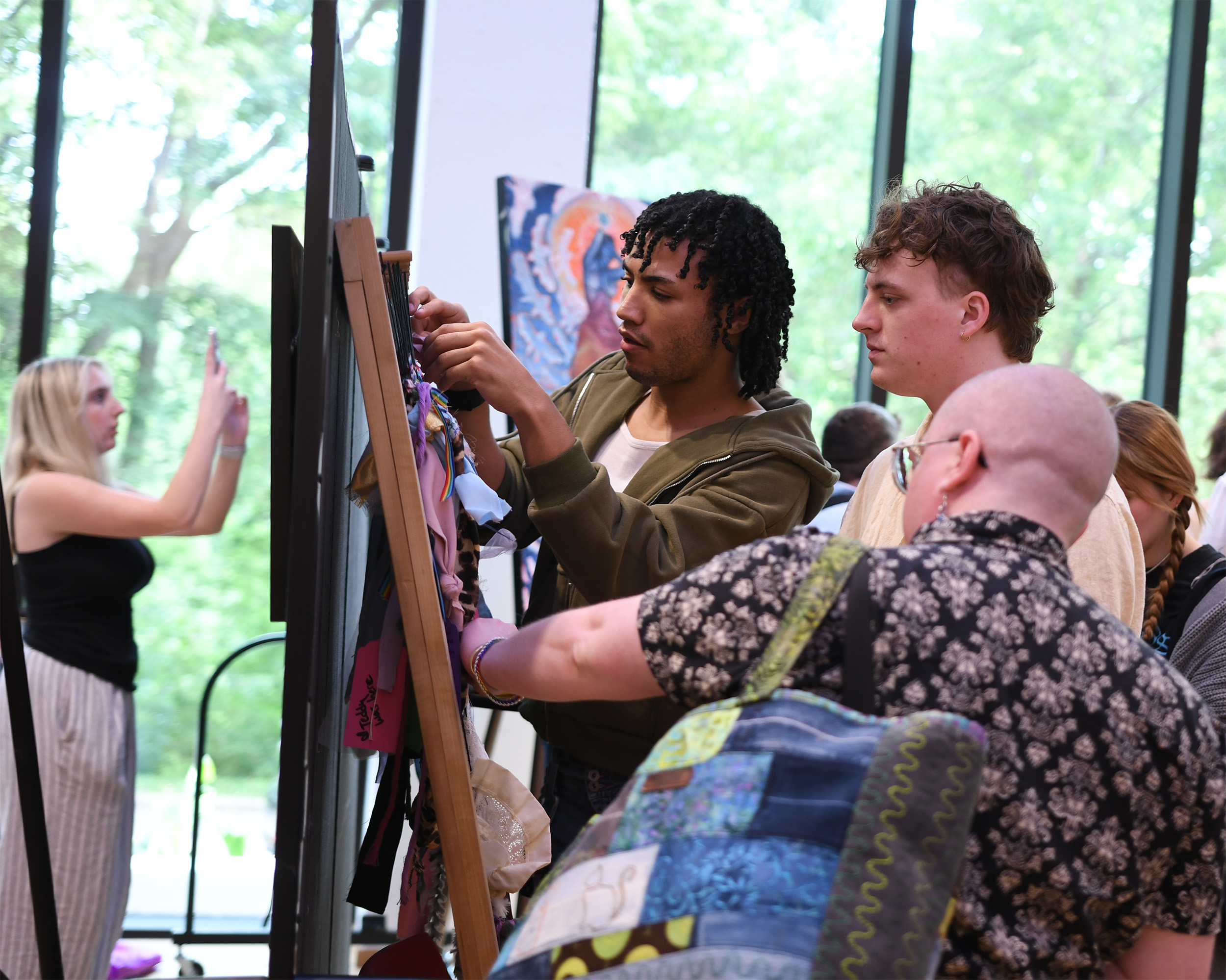 Visitors collaborate on an art piece at the museum