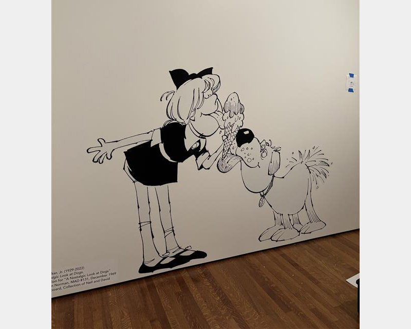 Large black and white wall graphic depicting a girl and dog eating from an ice cream cone rendered in cartoon style.